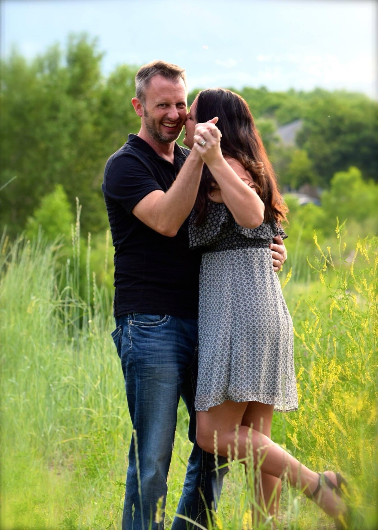 Couple dancing candidly outdoors