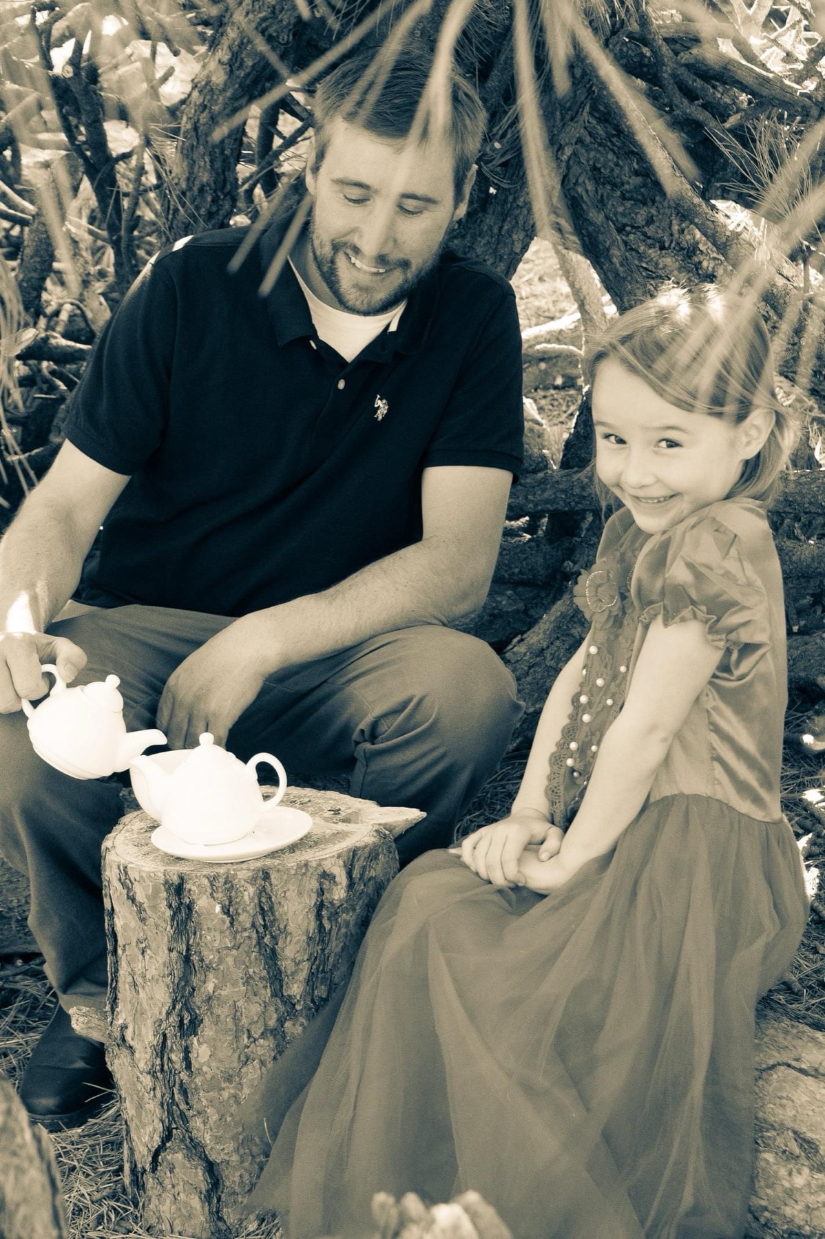 Father and daughter at a tea party, sepia