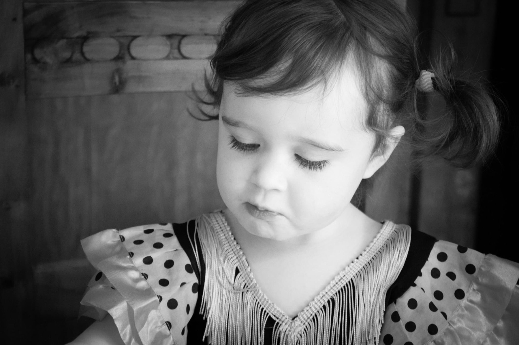 Girl with a teddy bear on the stairs, black and white