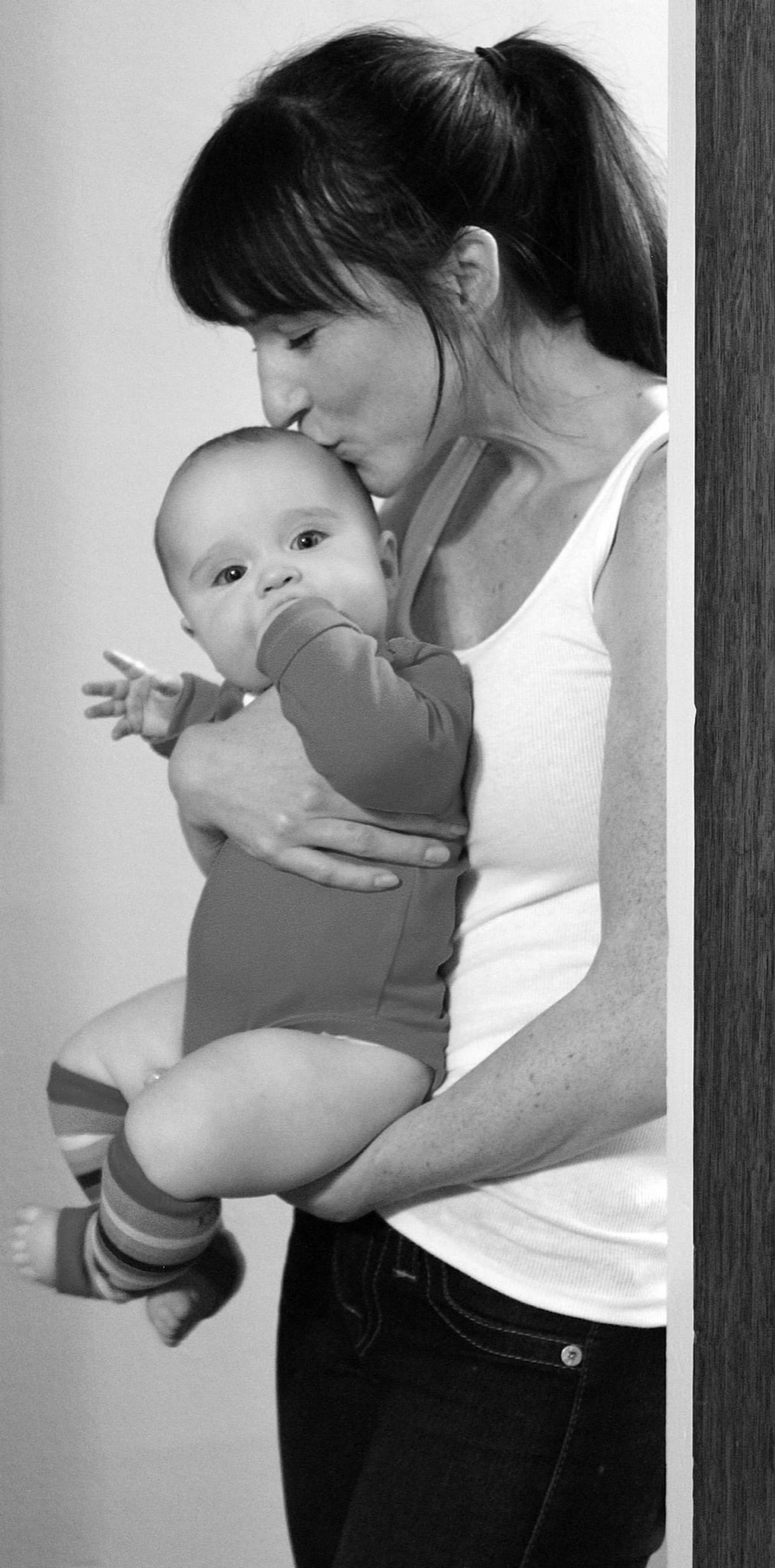 Mother and baby in a doorway, black and white