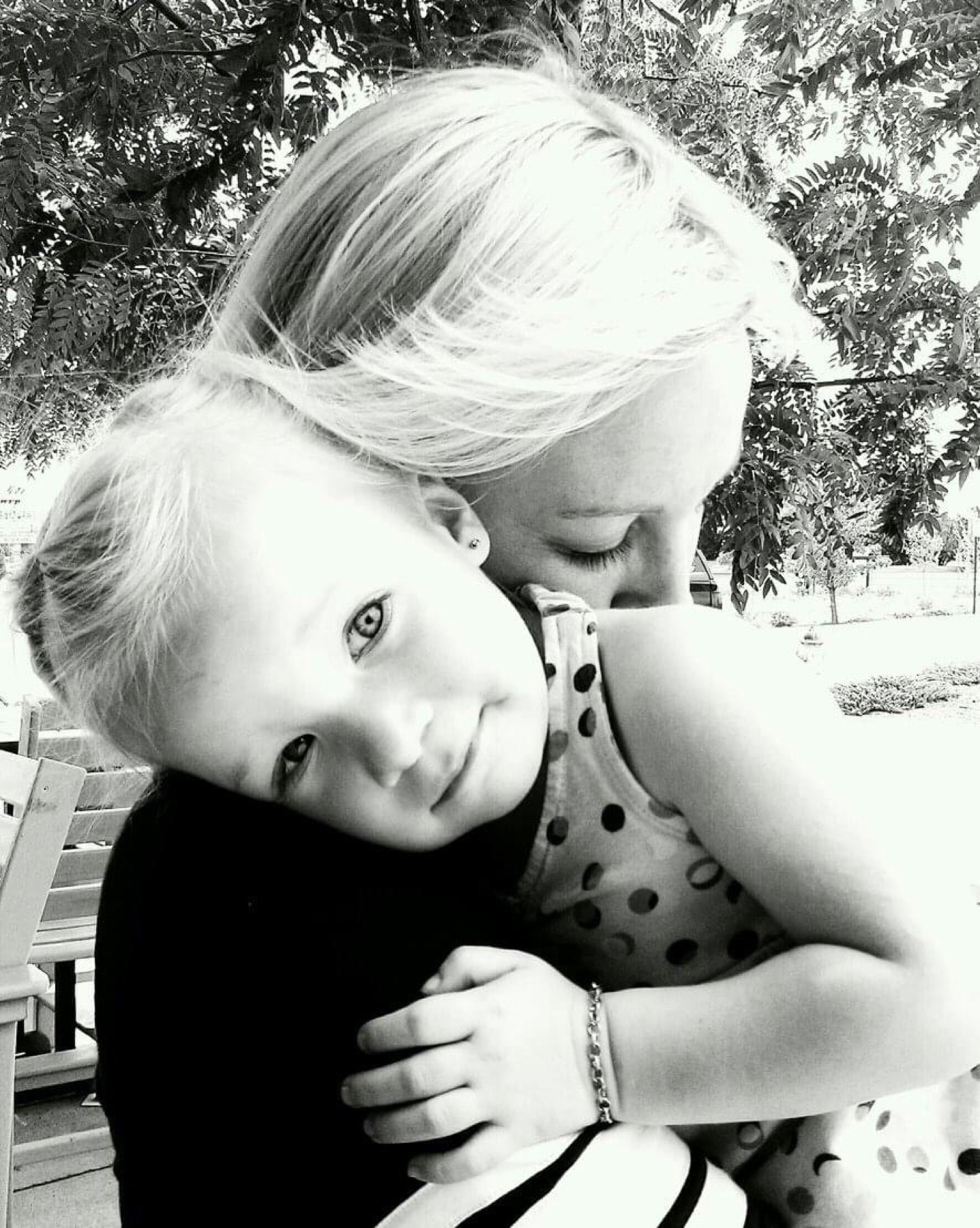 Mother and daughter embracing, black and white
