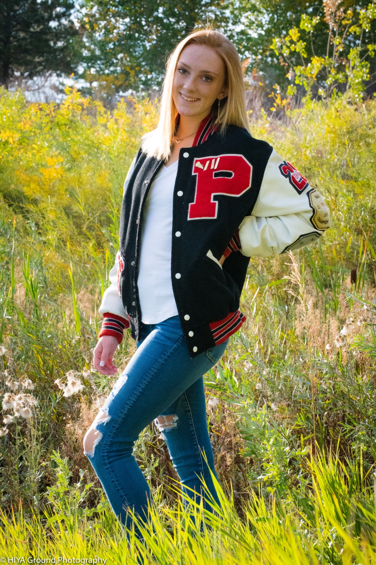 Senior portrait in a letterman jacket