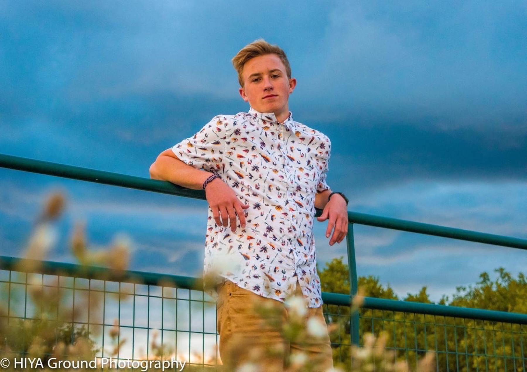 Senior portrait against a stormy sky